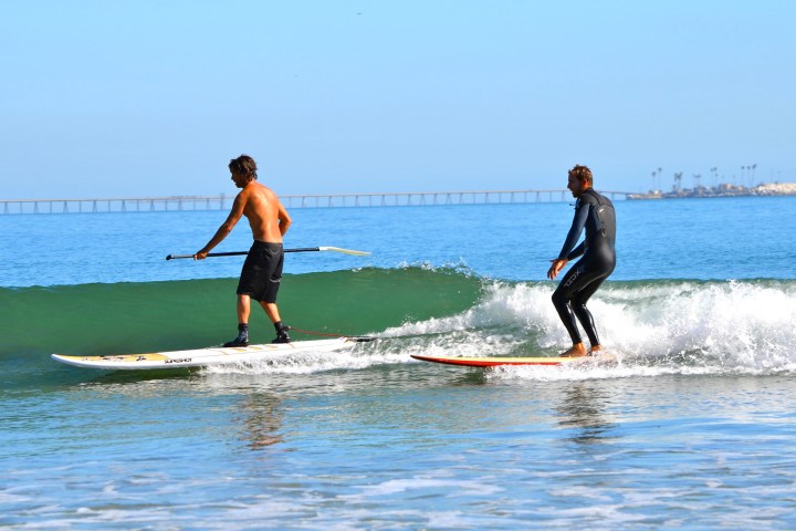 a man riding a wave on a surfboard in the water